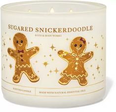 a candle with two gingerbreads on it and the words, sugared snickkerdoodlele