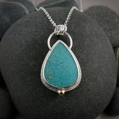 This handcrafted necklace from our Fabulous Fossils Collection features a stunning piece of opalized fossil wood in a bright tropical blue colour. The 14K gold accent ball adds the perfect touch to this sterling silver piece, making it a truly unique and eye-catching accessory. Expertly crafted and sure to be a conversation starter.  Product Details: * This necklace is ready to ship.   Will ship within 1-3 business days of ordering. * Sterling silver, 14K gold, opalized fossil wood. * Pendant me Unique Teardrop Necklace With Hallmark, Unique Teardrop Hallmarked Necklace, Unique Hallmarked Teardrop Necklace, Unique Polished Turquoise Necklace, Fossil Jewelry, Tropical Blue, Wood Necklace, Necklace Unique, Wood Pendant