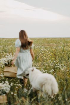 a woman in a field with a dog