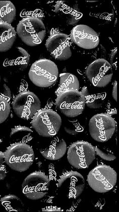 black and white photograph of coca cola bottle caps