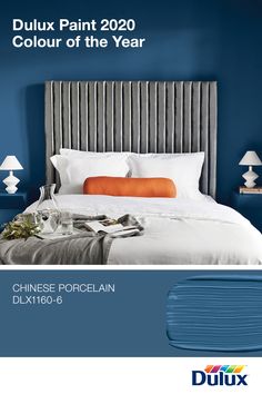 a bedroom with blue walls and white bedding in the color of the year chinese porcelain