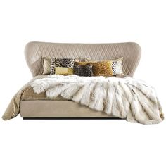 a bed with some pillows and blankets on top of it, in front of a white background