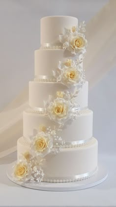 a three tiered wedding cake with flowers on it