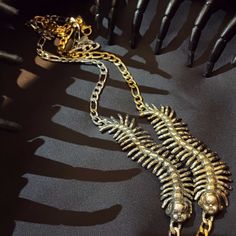 The Centipede Girl Necklace is as creepy and cute as it gets. Available in silver or gold tone, this necklace is sure to instill the back-off vibes that you might want to illicit on an especially dark day, to keep the real creeps away. Details below!Dimensions:The centipede girl measures 2.75 inches long and half of an inch wide. The chain is adjustable, measuring 15" at its shortest and 17 inches at its longest.Materials:Silver Tone: White brass charm on a silver tone chain.Gold Tone: Brass cha Metal Necklace With Lobster Clasp For Halloween, Metal Necklaces With Lobster Clasp For Halloween, Halloween Metal Necklace With Adjustable Chain, Gold Punk Jewelry For Halloween, Punk Gold Jewelry For Halloween, Punk Style Gold Jewelry For Halloween, Gold Punk Clavicle Chain Necklace, Edgy Metal Necklace For Halloween, Gold Punk Necklace For Halloween