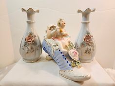 three porcelain vases with figurines on them