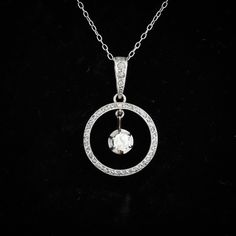 An antique Edwardian diamond circle pendant, set in 18ct gold and platinum. It is set with an old mine cut diamond to the centre, on a knife edge setting which moves, and is surrounded by 42 rose cut diamonds, including the diamond set bail. It is completely handmade and is a fine example of the craftsmanship of the era. The central diamond weighs approx 0.23ct, and is K/L in colour,. SI1/SI2 clarity. Diamond: Old Mine Cut, Colour K/L, clarity SI1/SI2, length 3.98mm, width 3.88mm, depth 2.20mm. Dazzling Hallmarked Round Diamond Necklace, Hallmarked Round Dazzling Diamond Necklace, Dazzling Round Diamond Necklace, Hallmarked, White Gold Rose Cut Round Diamond Necklace, White Gold Round Rose Cut Diamond Necklace, White Gold Diamond Necklace With Rose Cut Diamonds, Classic Round Diamond Necklace With Rose Cut Diamonds, Sterling Silver Round Diamond Necklace With Rose Cut Diamonds, Sterling Silver Diamond Necklace With Rose Cut Diamonds