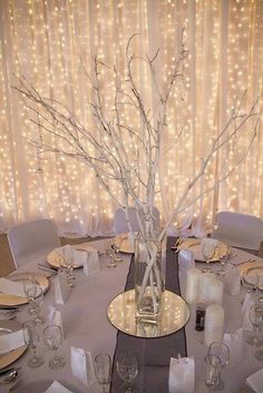 a dining room table is set with silverware and place settings for an elegant dinner