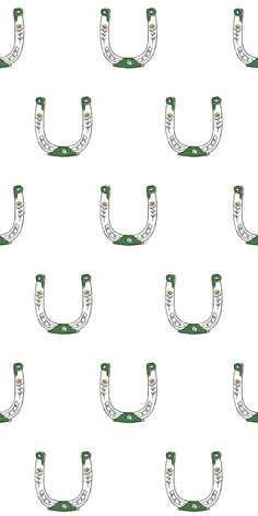 a pattern of green and white objects on a white background that looks like horseshoes