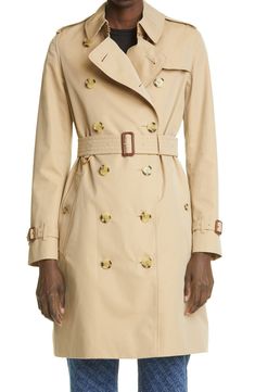 This mid-length version of the brand's most popular trench is made from breathable, weatherproof cotton gabardine, which Thomas Burberry invented in 1879. The collar—painstakingly hand sewn using over 180 stitches—can be popped to reveal the house check. Style Name:Burberry The Kensington Mid Heritage Trench Coat. Style Number: 6223112. Burberry Store, Thomas Burberry, Trench Coat Outfit, Blue Trench Coat, Burberry Coat, Burberry Trench, Burberry Trench Coat, Trench Coat Black, Outerwear Coats