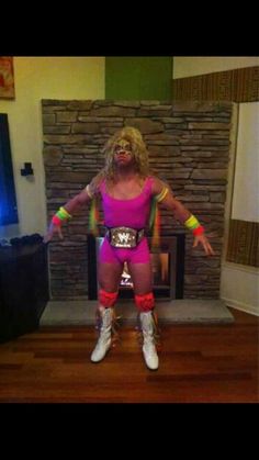 a woman in pink and yellow wrestling gear