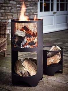 a fire pit sitting on top of a wooden table next to a chair and door