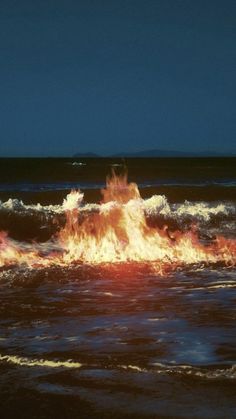 a fire hydrant spewing out flames into the ocean