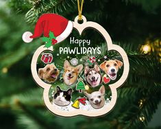 a christmas ornament with three dogs hanging from it's side on a tree