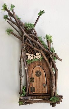 a wooden house made out of branches and logs with moss growing on the outside wall