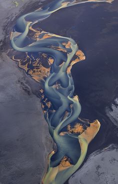 an aerial view of a river running through land