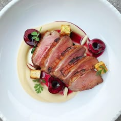 a white plate topped with meat and veggies