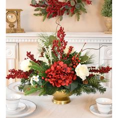 a vase filled with red and white flowers on top of a table next to a clock