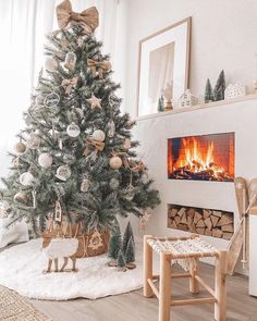 a decorated christmas tree in front of a fireplace