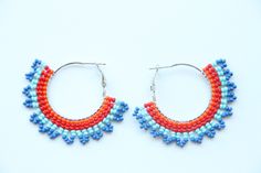 These hoop earrings are made using traditional freehand beading techniques. Earrings are made of quality Czech beads and strong thread. Stainless steel hoops. Earrings are 4.5 cm ( 1.8 inches)  length and 5 cm ( 2 inches) width. Colors: orange,red,blue. 100% handmade. Don't forget to check out my other hoop earrings in the store. Maybe you will find exactly what you are looking for. https://www.etsy.com/shop/SandasHandmades The photo may not convey true colors. This may depend on the settings of Small Hoop Beaded Earrings With Spacer Beads As Gift, Small Hoop Beaded Earrings With Spacer Beads For Gifts, Festive Beaded Hoop Earrings With Round Beads, Festive Beaded Hoop Earrings, Festive Multicolor Beaded Hoop Earrings, Handmade Beaded Hoop Earrings Gift, Handmade Beaded Hoop Earrings For Gifts, Gift Dangle Hoop Earrings With Spacer Beads, Traditional Hoop Earrings With Colorful Beads For Gift