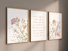 three framed art prints with flowers on the wall above them, one has a poem