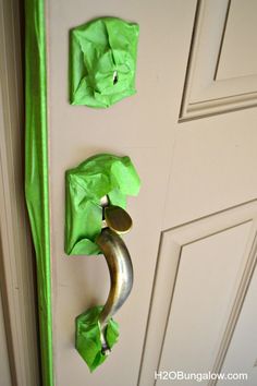 green tissue paper hanging on the front door with a banana shaped object attached to it