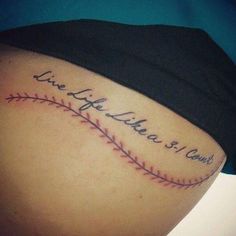 a woman with a baseball tattoo on her lower back and the words live life is good written in cursive writing