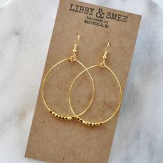 These big beaded hoops in gold or silver are the perfect simple statement — just right for those busy mornings when finding something that matches your outfit is just too much to ask. stainless steel ear wire and hand-shaped hoop with faceted beads choose gold-plated or silver-plated lead-free and nickel-free plastic earring back 2.5" long and 1.5" wide (each pair is handmade so sizes can vary slightly) packaged on a kraft earring card in a clear resealing bag Hoop Earrings Big, Gifts For Girlfriends, Earrings Gold Hoops, Plastic Earrings, Earrings Big, Dangle Hoop Earrings, Earring Cards, Red Earrings, Beaded Hoop Earrings