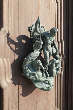 a statue on the side of a wooden door