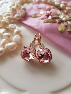 Every Girl loves a pair of Beautiful Sparkly Swarovski Crystal earrings and these Beautiful Pink Swarovski Crystal earrings are seriously lovely. These earrings are simply gorgeous, featuring a lovely cushion cut Light Rose Swarovski Crystal, which is both Elegant and Stunning. The Light Rose colour is simply divine, perfect for those that love pink ! The Beautiful Crystal is 12mm and has been set in a Quality Rose Gold plated leverback setting (Nickel Free) and features a lovely small crystal i Rose Gold Crystal Earrings For Anniversary, Rose Gold Crystal Earrings For Gift, Rose Gold Round Crystal Earrings For Party, Rose Gold Crystal Bridal Earrings For Gift, Sparkling Rose Gold Bridal Earrings Gift, Rose Gold Crystal Earrings, Rose Gold Cubic Zirconia Earrings For Bridesmaids, Pink Swarovski, Light Rose