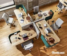 an overhead view of office desks and chairs