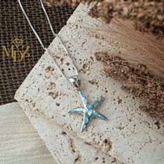 Add a touch of the ocean to your outfit with this stunning Blue Starfish Necklace made with Mother of Pearl. This ocean-inspired beach jewelry piece is perfect for adding a pop of color and whimsy to your summer wardrobe. This startfish necklace is sure to make a statement wherever you go. Bring a piece of the beach with you wherever you wander with this beautiful summer jewelry accessory. ------------------------ Item Details ------------------------ Blue Mother of Pearl Starfish Necklace Penda Starfish Charm Shell Necklace As A Gift, Starfish Shell Necklace As A Gift, Starfish Charm Shell Necklace Gift, Starfish Charm Shell Necklace For Gift, Ocean-inspired Strand Jewelry With Starfish Charm, Ocean-inspired Starfish Shell Necklace As Gift, Ocean-inspired Starfish Shell Necklace, Beachy Starfish Charm Jewelry For Gifts, Gift Ocean-inspired Shell Necklace With Starfish Charm