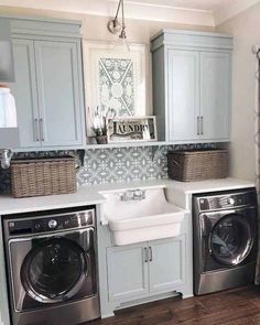 a washer and dryer in a laundry room next to each other with baskets on them