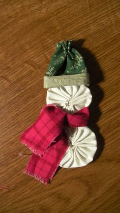 three pieces of cloth tied together on top of a wooden table