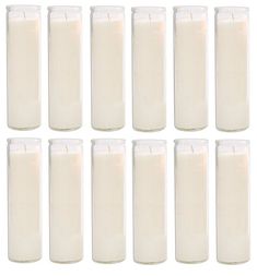 twelve candles are lined up in rows on a white background