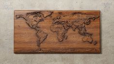 a wooden plaque with the map of the world carved into it's sides on a wall