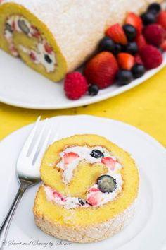 two white plates topped with fruit and pastry