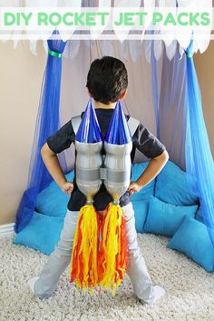 a young boy standing in front of a rocket ship