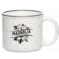 a white coffee mug with the words magnolia on it