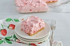 a piece of cake sitting on top of a plate next to a fork and napkin