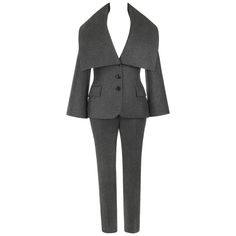 Alexander McQueen Pre-Fall 2009 two piece gray wool cashmere pant suit. Long bell sleeve blazer. Over-sized collar. Three center front button closures. Two front welt flap pockets. Single center back vent. Fully lined. Matching slim fit trousers. Five belt loops. Center front zip fly, hook and eye and button closure. Front hip pockets. Partially lined. Marked Fabric Content: "Composition 90% Wool 10% Cashmere, Lining 52% Acetate 48% Rayon". Marked Size: "44" (Jacket); "40" (Pants). Measurements: Pant Suit Set, Black Tuxedo Jacket, Cashmere Blazer, Cashmere Pants, Cartier Panthere, Leather Pant, Capes For Women, Black Tuxedo, Tapered Trousers