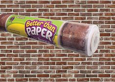 a roll of paper hanging from the side of a brick wall