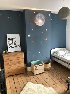 a child's bedroom with blue walls and stars on the wall