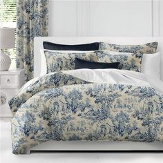 a bed with blue and white comforters in a room