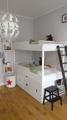 there is a bunk bed with two sets of drawers and a ladder in the room