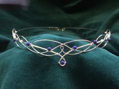 Beautiful handmade silver plated lapis lazuli circlet. The design is crafted from just two lengths of wire emulating traditional Celtic knotwork with beautiful blue lapis lazuli gemstones. The circlet is open at the back with loops for ribbon or cords to be attached to enable the circlet to be held in place. You can also pin it into place if preferred. The circlet is entirely handmade and therefore it is sturdy yet flexible and very comfortable to wear. The design element of the headdress measures 22.5cms (9 inches) across and 2.5cms (1 inch) from top to bottom at the centre. The full circumference of the circlet is 52cms (20 and a half inches). It is no problem to make the circlet smaller or larger, just leave a note with the size you would like it to be when you order. If you would like Elven Circlet, Wedding Circlet, Elf Jewelry, Celtic Knotwork, Blue Lapis Lazuli, Wedding Tiara, Boho Bride, Tiaras And Crowns, Wedding Hair Accessories