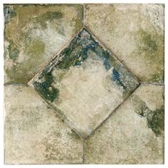 an old tile floor with green and blue paint on it's edges, in the shape of a square