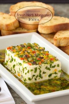 a white plate topped with food next to bread