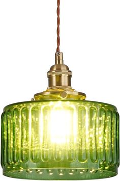 a green glass light hanging from a ceiling