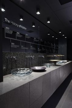 a row of sinks sitting next to each other on top of a counter in a bathroom