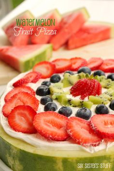 a watermelon fruit pizza with blueberries, kiwi and strawberries on top